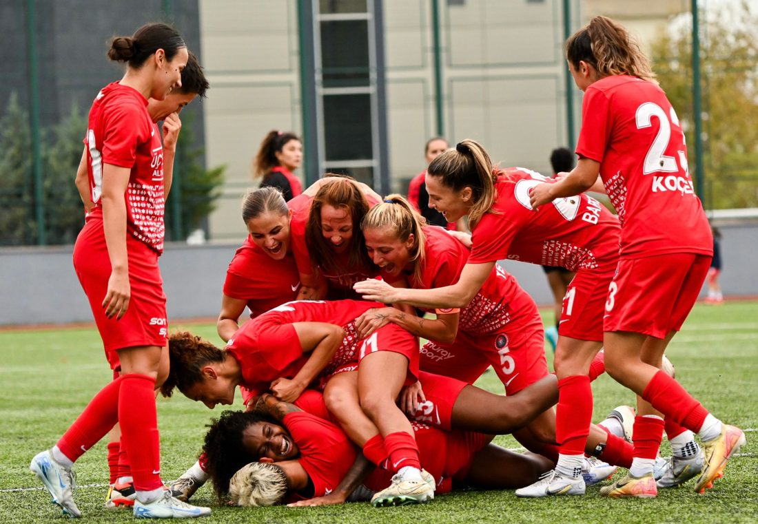 Teammates piling on to celebrate a goal